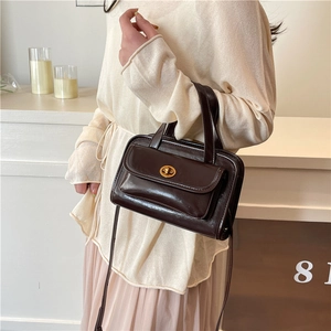 Deep brown glossy rectangular handbag with gold twist lock and adjustable shoulder strap