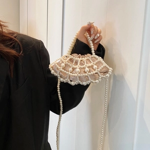 Detailed view of champagne satin shell bag with exquisite pearl mesh and beaded strap