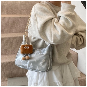 Silver hobo bag with cloud texture, gold chain strap and brown plush charm detail