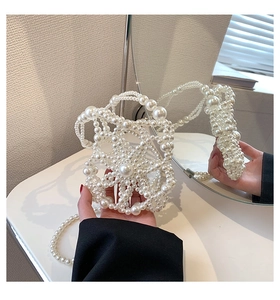 Detailed view of handmade pearl bucket bag featuring intricate woven flower hollow patterns