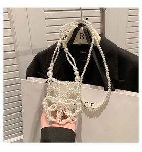 Detail view of a handmade pearl woven crossbody bag with elegant floral pattern design