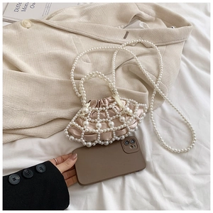 Mini pearl beaded crossbody bag with pink satin pouch shown next to a smartphone