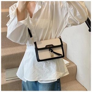 Model wearing a retro contrast square crossbody bag with beige weave and black leather trim