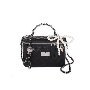 Quilted black leather chain bag with pearl bow and silver hardware on white background