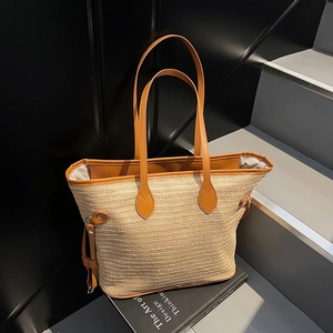 Minimalist woven tote bag with brown leather handles on stairs background