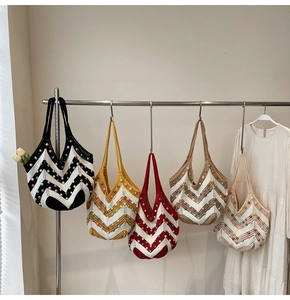 Detail of colorful beaded woven tote bags in bohemian style on showroom hangers