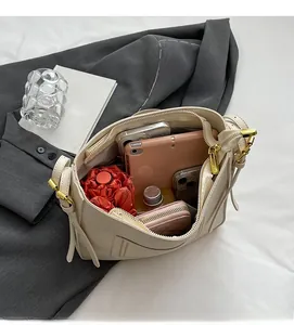 Internal view of cream bucket bag showing large capacity for tablet and accessories