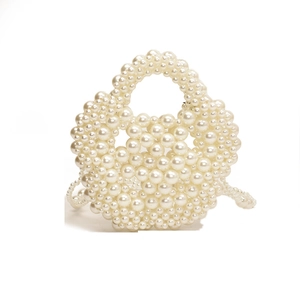 Elegant handmade pearl woven handbag with a round handle for evening parties
