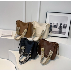 Detail view of four casual bucket bags in multiple colors with patterned woven straps
