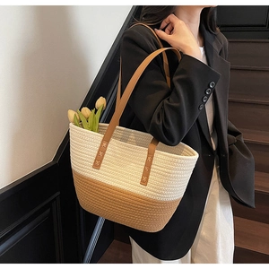 Detail of hand-woven cotton rope tote bag with bicolor weave and leather shoulder straps
