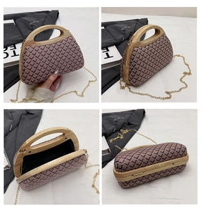 Detail view of woven evening bag showing wooden handle, chain strap and black lining
