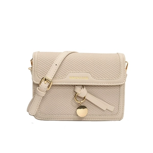 Beige canvas shoulder bag with contrast leather trim and a gold buckle strap