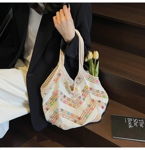 Detail of woven tote bag featuring colorful beads and chic tulip decoration