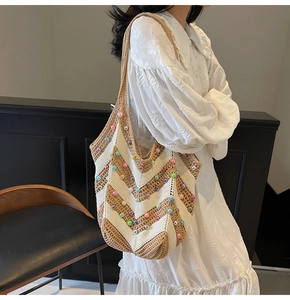 Detail of bohemian knit tote bag with colorful beads and chic wave pattern texture