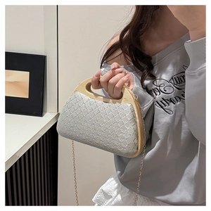 Macro detail of woven texture and natural wooden handle on the stylish evening clutch bag