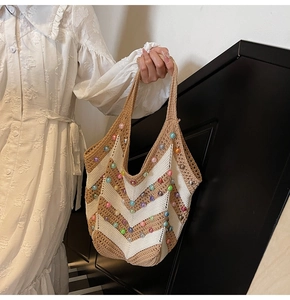 Detail of hand-woven crochet tote bag with colorful beads and striped knit texture