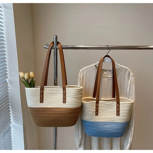 Detail of handwoven cotton tote bags with leather handles and textured color-block design