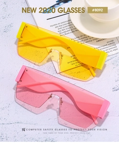 Flat lay of pink and neon yellow shield sunglasses with side panels and a coffee cup