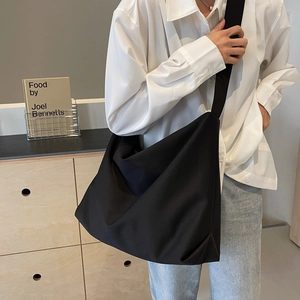 Minimalist large black tote bag with wide shoulder strap in Japanese commuter style
