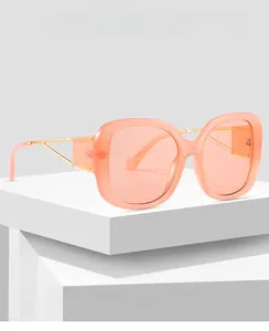 Macro detail of peach square frames with geometric gold metal temples for protection