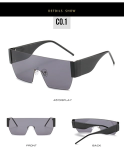 Multiple views of oversized black one-piece frame sunglasses with grey tinted lenses