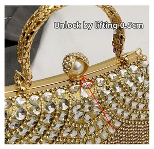 Detailed close-up of the rhinestone evening bag featuring a pearl clasp lock mechanism
