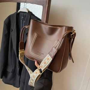 Retro dark brown bucket bag with a decorative geometric jacquard strap for women