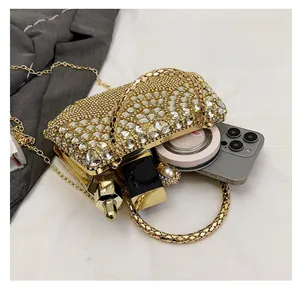 Macro view of gold evening bag interior showing capacity for phone and cosmetics