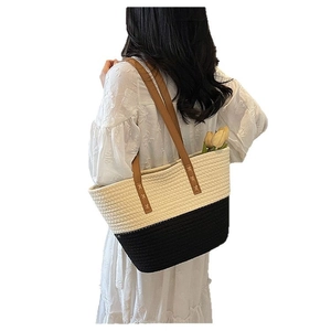 Large cotton rope woven tote bag with two-tone design and brown leather handles