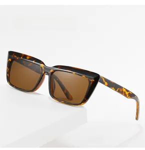 Detail of oversized square tortoiseshell sunglasses on a minimalist white platform