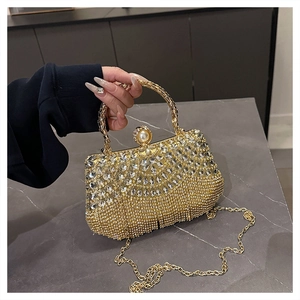 Detail of luxury rhinestone evening bag with pearl clasp and golden chain strap