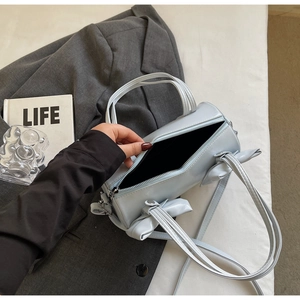 Detailed top view of light blue bow barrel bag showing spacious interior and zipper