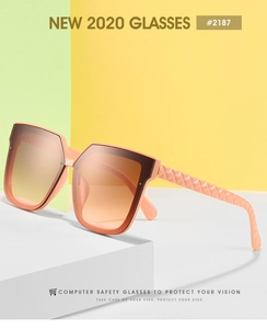 Detail of square oversized sunglasses with pink orange frame and textured diamond temples