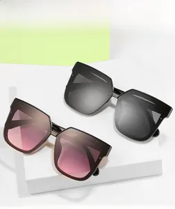 Close-up of square cat-eye sunglasses with thick black frames and detailed CE branding