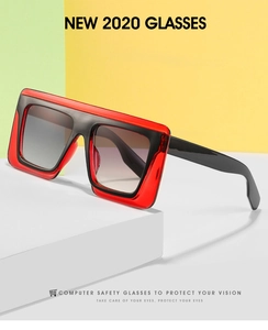 Detail of square oversized glasses with red translucent frames and gradient lenses