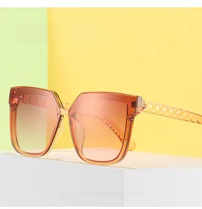 Detail showing the stereoscopic diamond pattern texture on square amber sunglasses temples