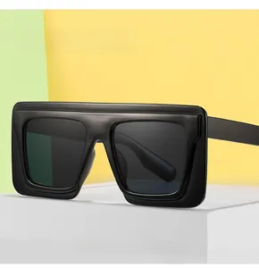 Detailed view of oversized black square sunglasses with matte finish and flat top shield design