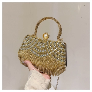 Detail of luxury evening bag showing sparkling rhinestones and golden fringe tassels