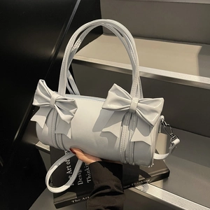 Light blue barrel bag with double bow decoration and adjustable shoulder strap