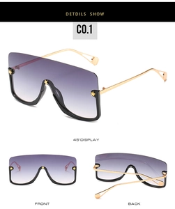 Detailed view of purple gradient oversized sunglasses with gold star rivet accents