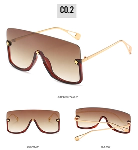 Detail of oversized star sunglasses showing gradient lenses and gold metal temples