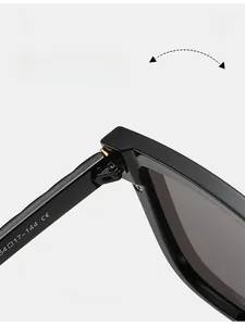 Detail of durable metal hinge and CE size markings on black square frame sunglasses