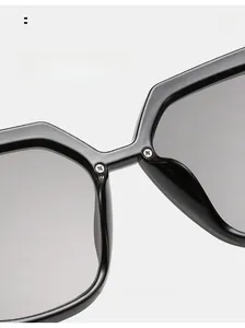 Detail of integrated comfortable nose pads on black frame sunglasses with metal screws