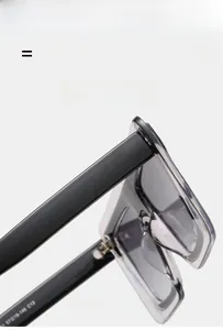 Detail view of transparent grey square frame sunglasses with black temples and serial code