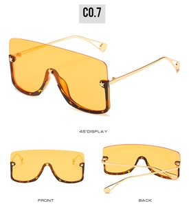 Three views of oversized shield sunglasses with orange lenses and gold star details