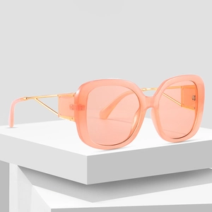 Stylish square oversized sunglasses in translucent orange-pink with gold metal temples
