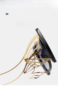 Détail de la branche en forme d'aile de papillon doré sur lunettes de soleil noires