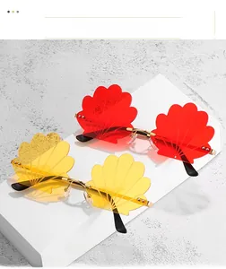 Detail view of red and yellow shell-shaped rimless sunglasses with wavy textured lenses
