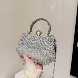 Elegant silver rhinestone clutch bag with pearl clasp and metal handle for evening party