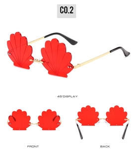 Three-way view of shell-shaped red sunglasses with golden metal frame and creative design